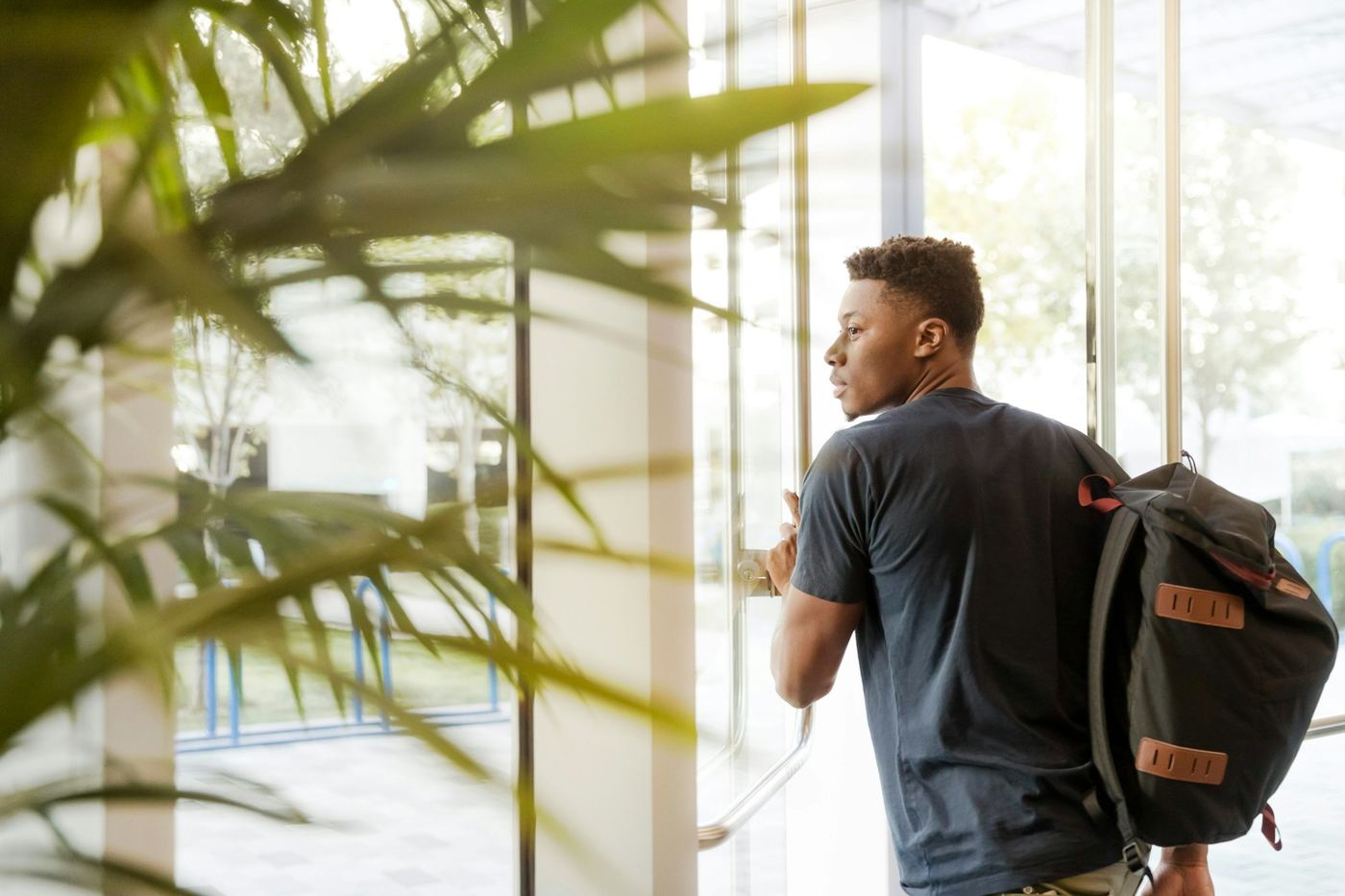 College student with a backpack heading out the door